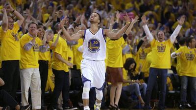 Fans cheer as Golden State Warriors guard Stephen Curry reacts to making a three-point shot against the Memphis Grizzlies in Game 5 of their NBA play-offs second round series on Wednesday night. Ben Margot / AP / May 13, 2015