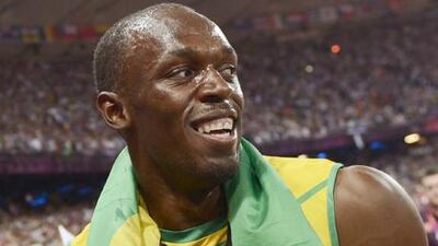Usain Bolt celebrates with spectators after Jamaica's win in the men's 4x100m relay at the London 2012 Olympics.