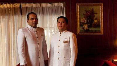 Concierges Luis Holly Fernandes (left) and Nicholas Tolentino during their final day's work at the Metropolitan Hotel. The hotel's closure has been compared to losing a home and family for many of its 400 employees.