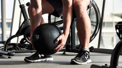 Adding extra weight to exercises, such as squats, can help get those glutes working. Courtesy Embody Fitness