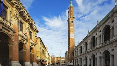 Piazza Signori in Vicenza, with the clock tower on the Basilica Palladiana, which houses shops in its arches. AWL Images / Getty Images