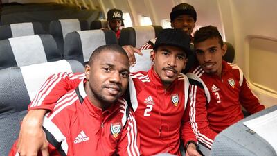 UAE football players, from left to right, Ismail Al Hammadi, Hassan Ibrahim and Walid Abbas shown on the plane to Canberra on Wednesday for the start of the 2015 Asian Cup.