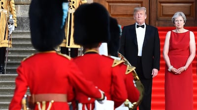 Donald Trump and Theresa May watch a military performance by the bands of the Scots, Irish and Welsh Guards. Bloomberg