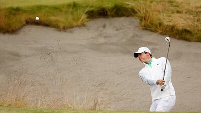 Rory McIlroy plays a bunker shot on the 13th hole. Mike Ehrmann / Getty Images / June 18, 2015