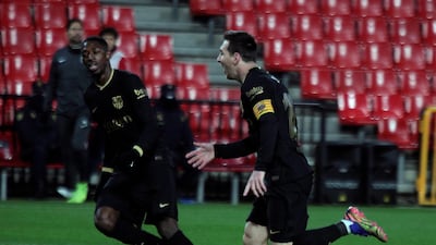 Lionel Messi celebrates with Barcelona teammate Ousmane Dembele during the 4-0 win at Granada. EPA