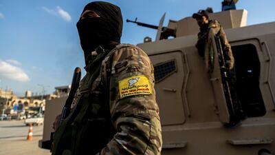 US -backed Syrian Democratic Forces (SDF) fighters stand guard at Al Naeem Square, in Raqqa, Syria, in 2022 (file photo). AP