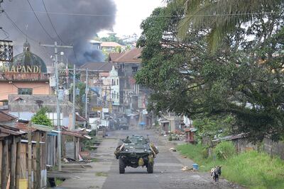 Smoke billows from burning houses in Marawi during fighting between the Philippine military and ISIS-linked militants who seized the city on Mindanao island for several months in 2017. AFP
