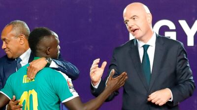 Mane is greeted by Infantino as he collects his medal. AFP