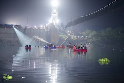 Indian rescue personnel conduct search operations after a bridge across the river Machchhu collapsed in Morbi. AFP