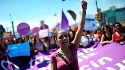 Protesters chant slogans at Taksim Square in Istanbul on Saturday, the ninth day of protests in the city. Bulent Kilic / AFP