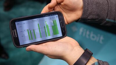 Data collected from the Fitbit Force is displayed on a smartphone at the 2014 International Consumer Electronics Show in Las Vegas, Nevada. Fitbit has issued a voluntary recall on its Force wristbands after reports began surfacing in January that the device was causing a painful skin irritation for some users. Justin Sullivan / Getty Images / AFP