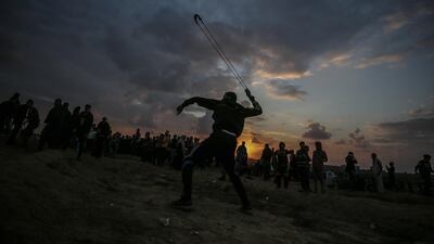 Palestinian protesters throw stones at Israeli troops during the clashes after Friday protests near the border between Israel and Gaza Strip in the east Gaza Strip. EPA