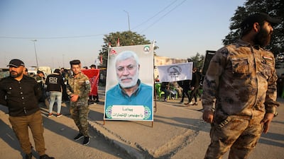 Iraqi supporters of the Hashed al-Shaabi paramilitary stand next to a portrait of Iraqi commander Abu Mahdi al-Muhandis during a demonstration in Baghdad's western Shoala neighbourhood. AFP