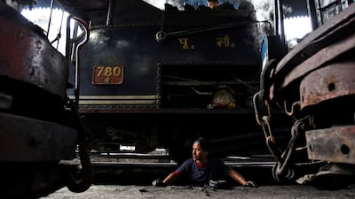 Workers repair a steam engine belonging to Darjeeling Himalayan Railway at a workshop in Darjeeling.