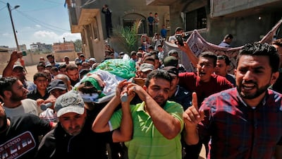 Palestinian mourners carry the body of Moumin Abu Eiada, 15, who was killed during a protest at the Israel-Gaza border fence, during his funeral in Rafah. AFP