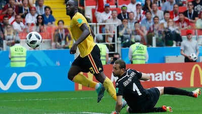 Belgium's Romelu Lukaku, left, scores his second and Belgium's third goal past Tunisia goalkeeper Farouk Ben Mustapha in a 5-2 win at Spartak Stadium in Moscow. Hassan Ammar / AP Photo