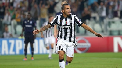 Juventus forward Carlos Tevez celebrates after scoring during the Uefa Champions League win over Malmo on Tuesday night. Marco Bertorello / AFP / September 16, 2014