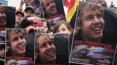 Fans of newly crowned Formula One world champion Sebastian Vettel hold up posters ahead of his arrival at his home town Heppenheim in 2010. AFP