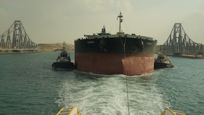 Tugboats tow MT Sounion through Egypt's Suez Canal, in Ismailia, on March 10. The Suez Canal Authority via Reuters