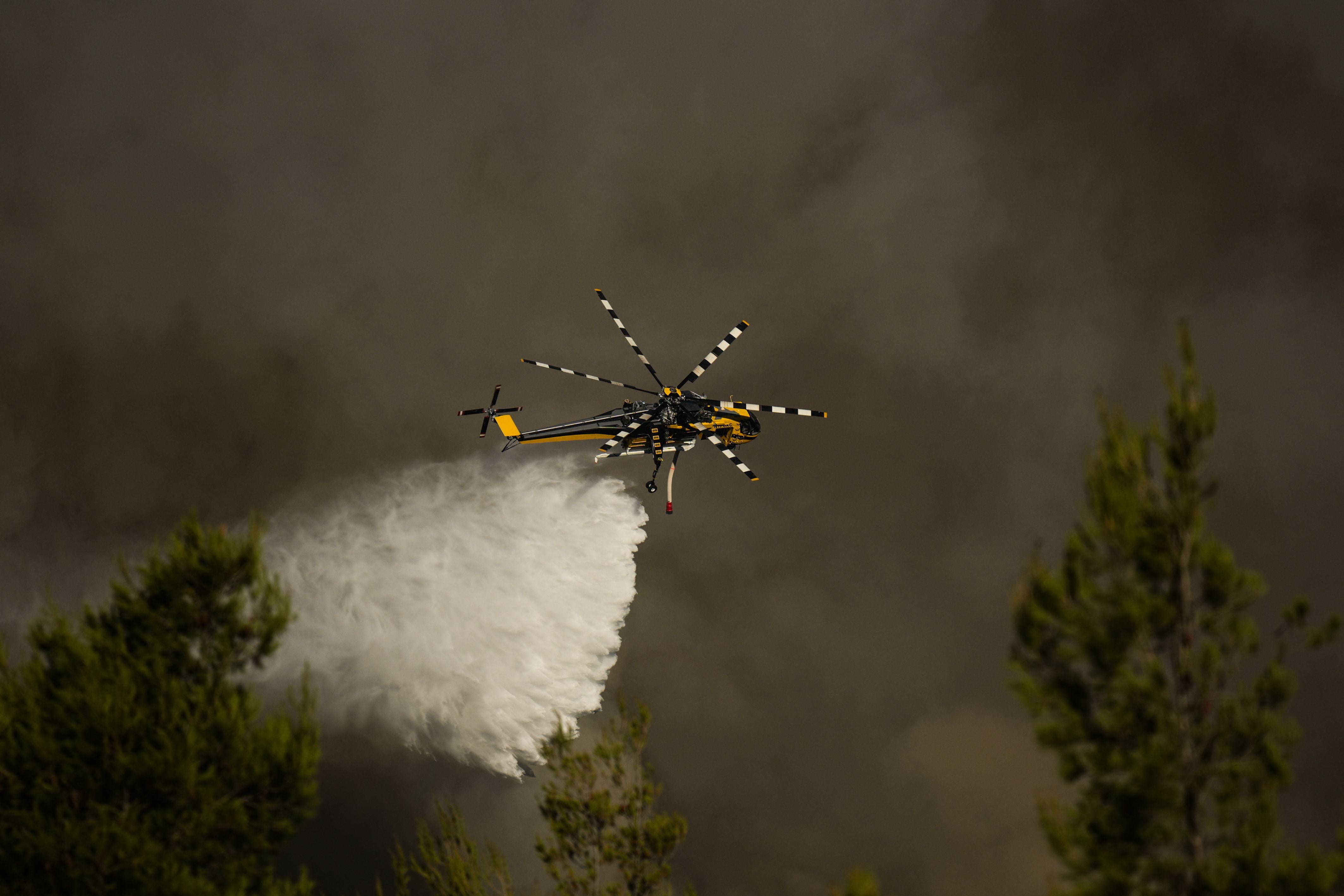Image linked from the original feed: Two crew members killed as helicopters collide while fighting fires near Athens