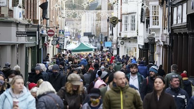 Christmas shoppers in Winchester, Hampshire, in southern England late last month. British Prime Minister Boris Johnson this week imposed further Covid-19 restrictions to curb the spread of Omicron. PA