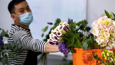 Florists at Florette in Dubai prepare bouquets for delivery with Covid-19 prevention measures in place. Chris Whiteoak / The National