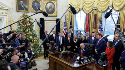 US President Donald Trump is joined by politicians and car manufacturers as he announces changes to fuel economy standards, in the Oval Office of the White House in Washington. EPA