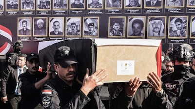 Syrian troops carry a coffin during the funeral ceremony of 47 people killed by the ISIS during its capture of Mosul in 2014, and whose remains were later found. AFP
