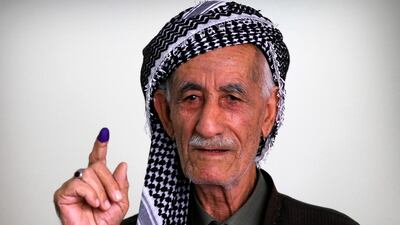An Iraqi Kurdish man shows his ink-stained index finger after casting his ballot for the parliamentary election at a polling station in Arbil, the capital of the Kurdish autonomous region in northern Iraq. AFP