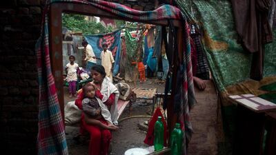 Pakistanis collect their belongings from their home damaged by heavy rain that hit Islamabad, Pakistan. BK Bangash / AP Photo