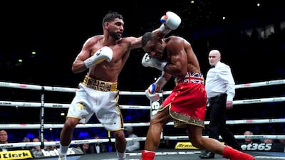Kell Brook ducks under a left from Amir Khan. PA