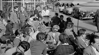 Paris in the spring: a crowded pavement cafe in the city of love in 1950. Getty