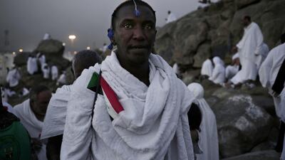 A Sudanese Muslim pilgrim makes his way up a rocky hill known as Mountain of Mercy, on the Plain of Arafat. Nariman El-Mofty / AP Photo