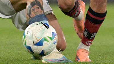 Racing Club de Avellaneda defender Gabriel Rojas' tattoo of Diego Maradona is visible as he fights for the ball against Flamengo's Giorgian de Arrascaeta during the Copa Libertadores semi-final second-leg match in Avellaneda, Buenos Aires province, Argentina. AFP