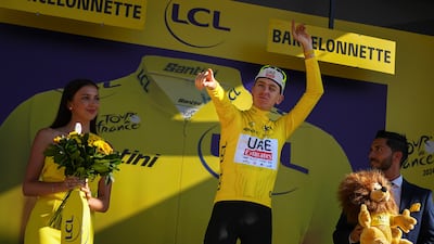 UAE Team Emirates rider and race leader Tadej Pogacar on the podium after Stage 18. AP