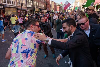 Mamdani greets runners near the half way point of the New York Marathon during a campaign event in the Brooklyn Borough of New York, on November 2. Bloomberg