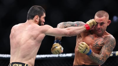 Islam Makhachev lands a punch on Dustin Poirier during their bout at UFC 302. AFP