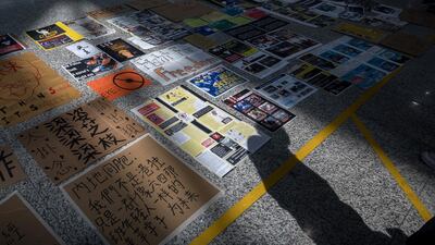 Placards and signs sit on the arrival hall floor at Hong Kong International Airport. Bloomberg