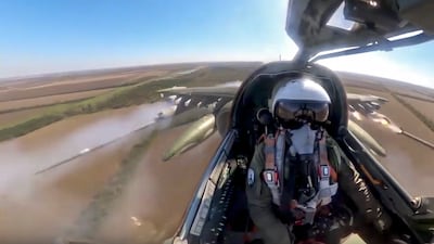 A Russian air force pilot is seen in the cockpit of his Su-25 as it flies on a mission in Ukraine. Photo: Russian Defence ministry press service via AP