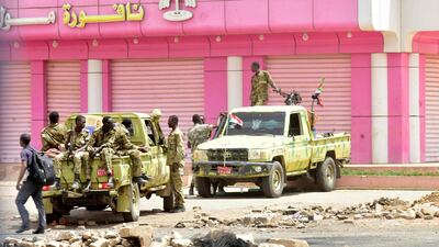 Sudanese soldiers stand guard in a street in Khartoum. AFP