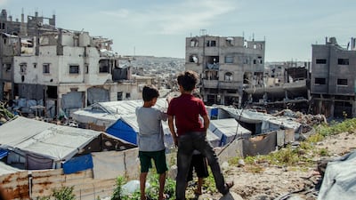 Children stand in the midst of destruction in Jabalia camp in northern Gaza. AFP