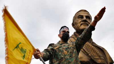 A Hezbollah fighter holds his group's flag in Beirut, Lebanon. AP