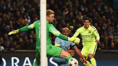 Luis Suarez of Barcelona scores the opening goal past Joe Hart of Manchester City to make it 1-0 on Tuesday night in the first leg of their Champions League last 16 tie. Laurence Griffiths / Getty Images
