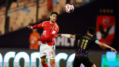 Al Ahly's Taher Mohamed in action with Al Ain's Bandar Al Ahbabi. Reuters