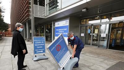 A nurse puts up a sign outside the Millennium Point Vaccination Centre in Birmingham. Reuters