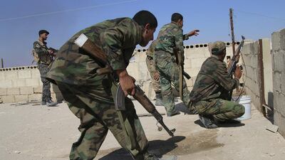 Syrian regime troops fight rebels in Achan in Hama province, where they have been making gains with the help of heavy air strikes by Russia. Alexander Kots / Komsomolskaya Pravda via AP / October 11, 2015