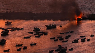 Smoke billows from a boat after a strike by Israel on the port of Gaza City. AFP