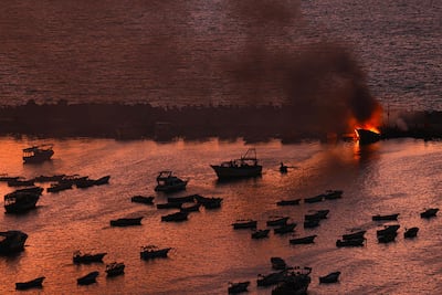 Smoke billows from a boat after a strike by Israel on the port of Gaza city. AFP