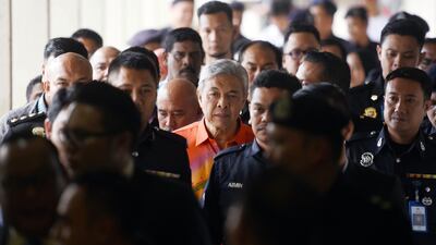 United Malays National Organization's (UMNO) President Ahmad Zahid Hamidi walks out of court room at Kuala Lumpur High Court in Kuala Lumpur. AP