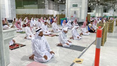 Muslim worshippers perform the "Tarawih" nightly prayer during the holy month of Ramadan, while keeping their distance amid the COVID-19 pandemic, at the Grand Mosque, Islam's holiest site, in the Saudi city of Mecca, late on May 8, 2020. AFP